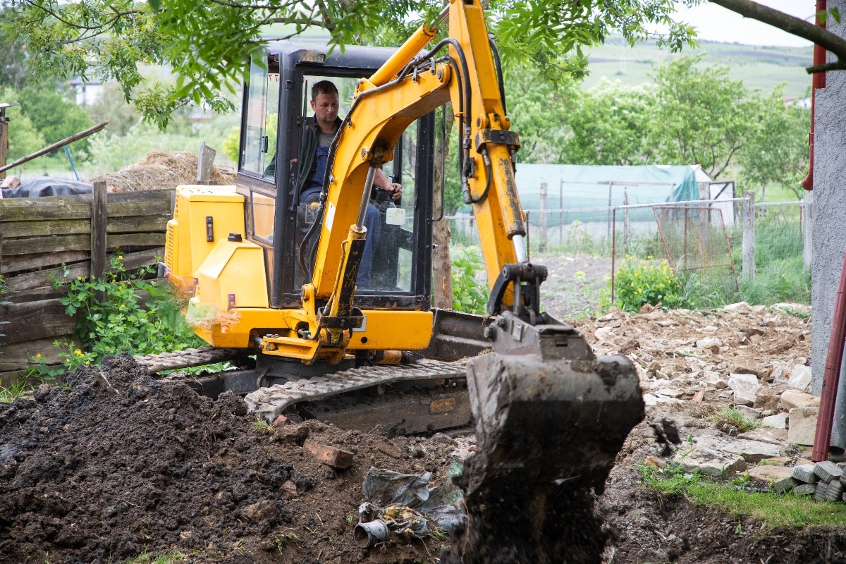 excavator with bucket lift digging in soil