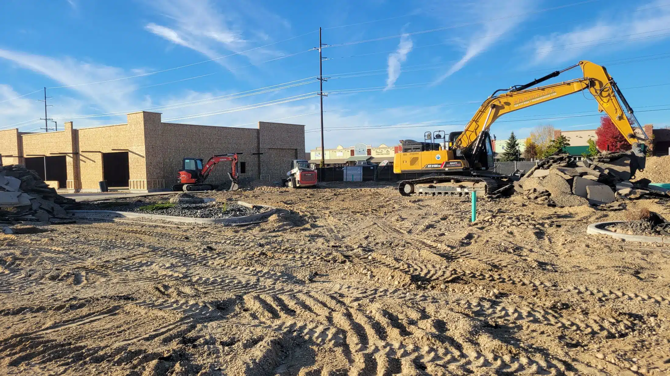 Excavator trenching for utilities on a Boise area site