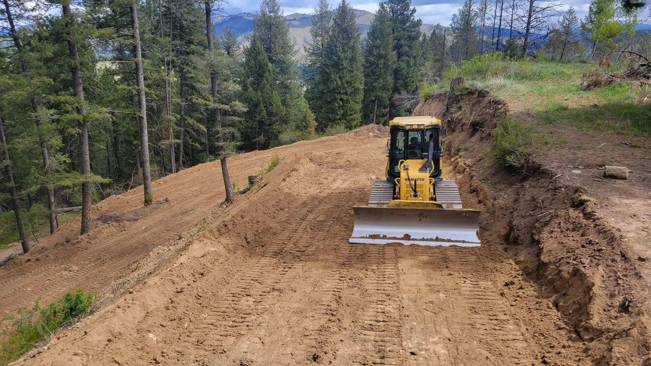 Excavation equipment shaping a building pad in Southwest Idaho