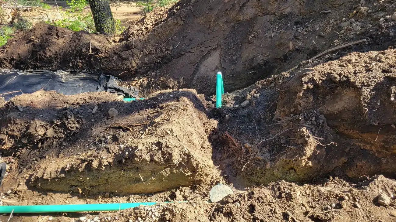 Crew excavating a failed septic drain field for replacement at a home in Star, Idaho