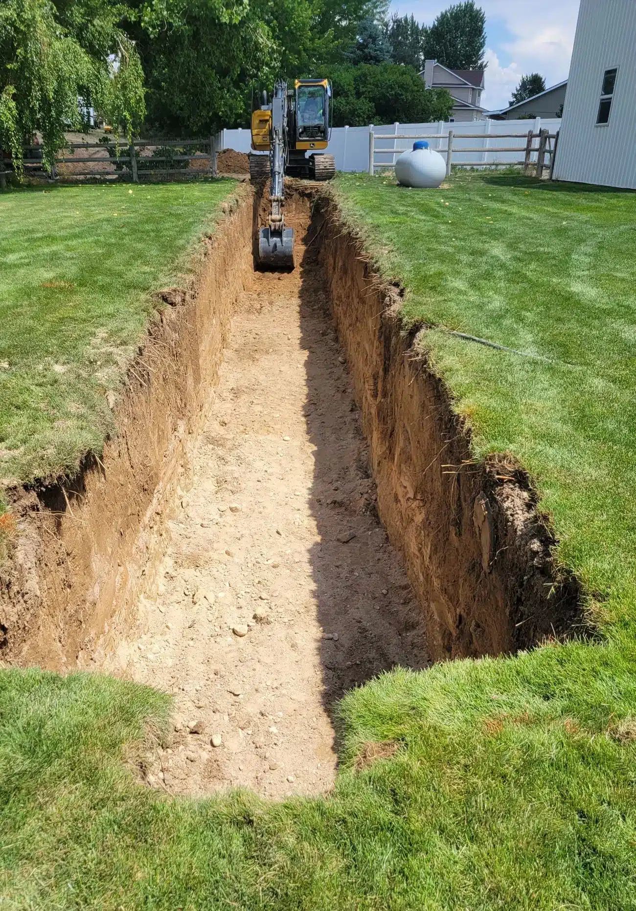 Deep utility trench excavated for new sewer service lines in Star, Idaho