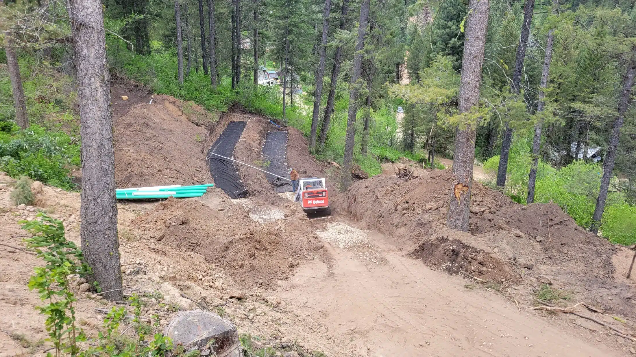 Excavator working on a septic system installation on a rural property near Nampa, Idaho