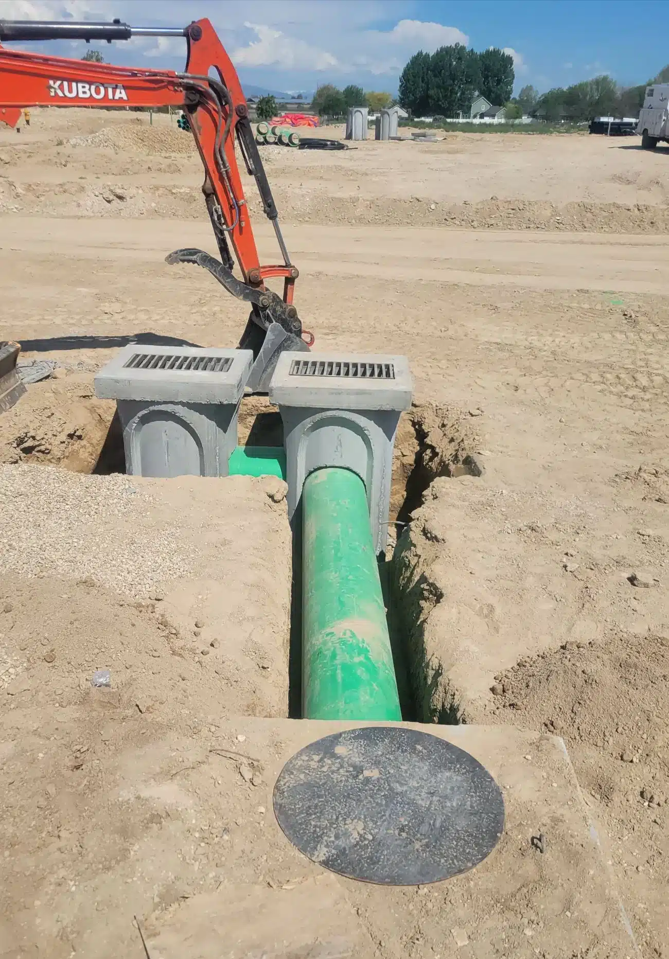 Crew installing new sewer pipe in an open trench on an Eagle property